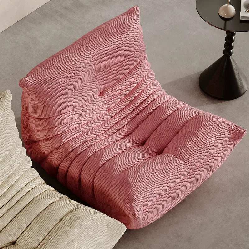 Minimalist modern pink corduroy Caterpillar armchair with soft textured upholstery for living room decor