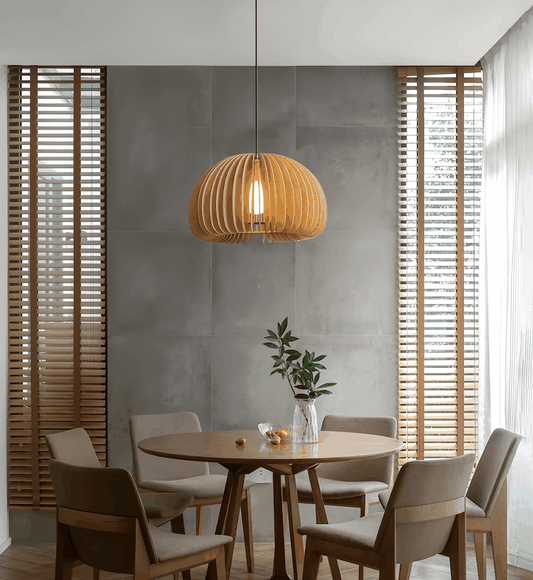 Wood pendant light hanging above a modern dining table with chairs in a stylish room
