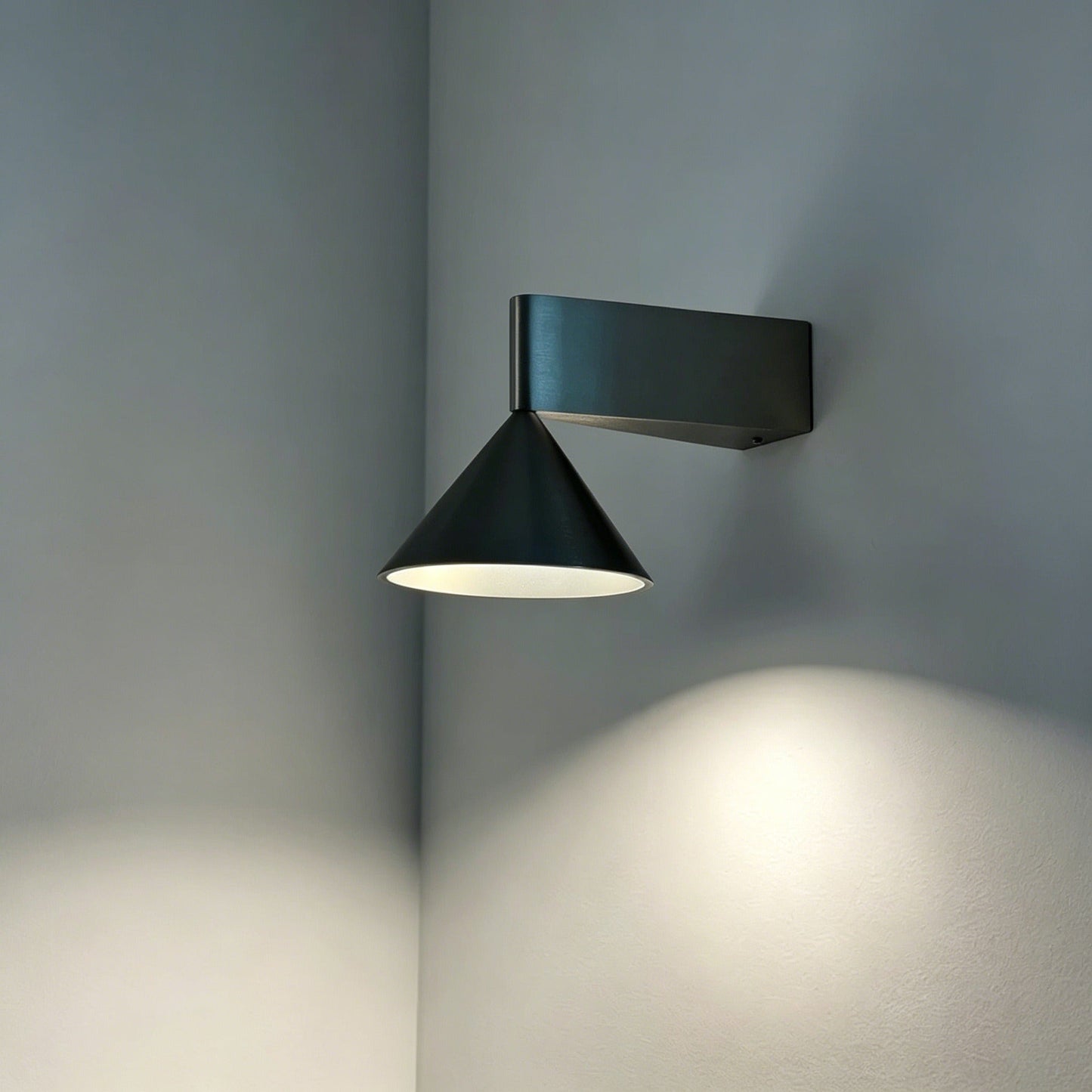 Italian minimalist modern wall sconce with conical aluminum design and warm LED light