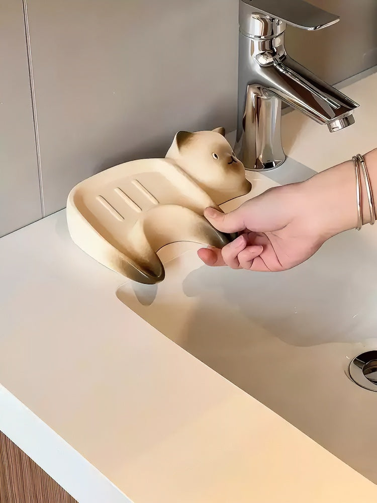 Ceramic cat soap dish with Siamese cat design and drainage grooves on bathroom countertop