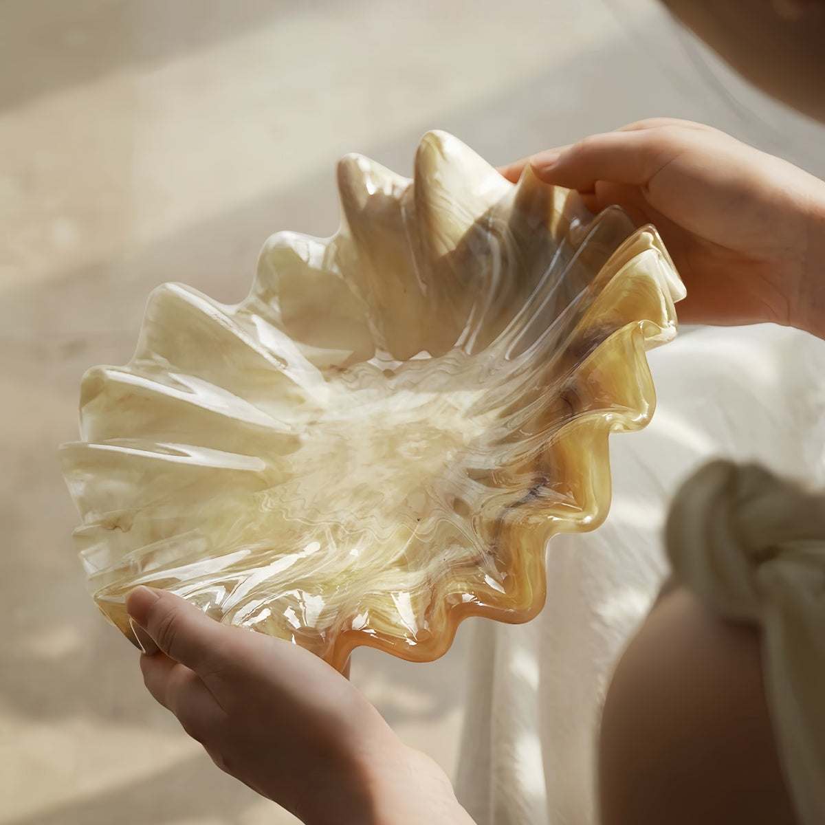 Vintage shell-shaped resin fruit bowl with scalloped edges on living room tabletop