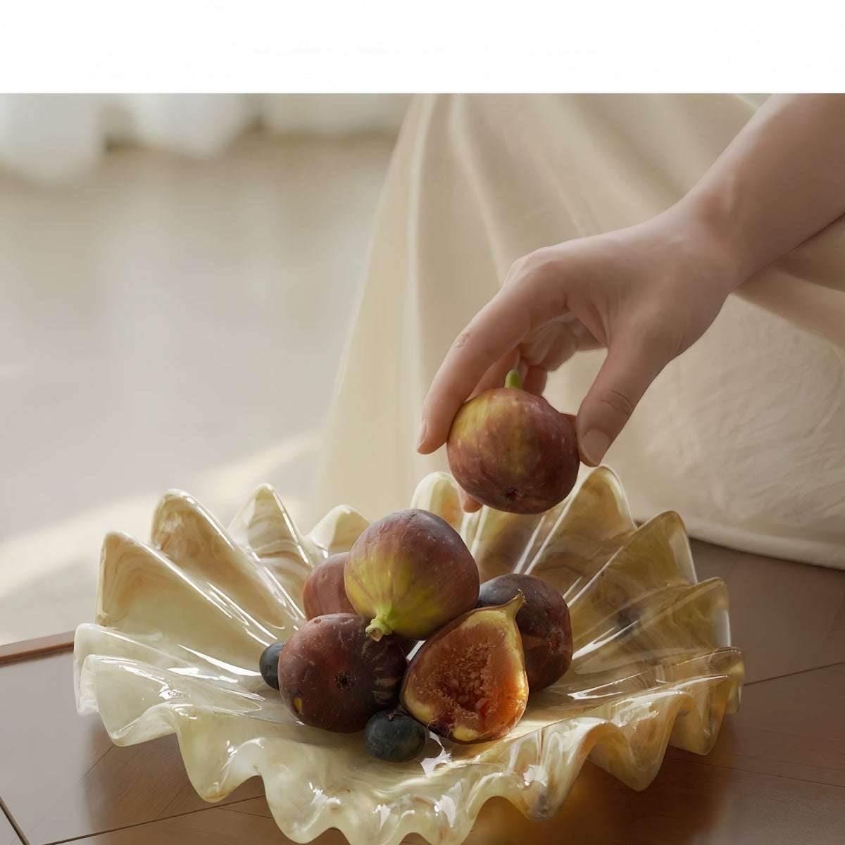 Vintage shell-shaped resin fruit bowl with wavy scalloped edges on living room tabletop