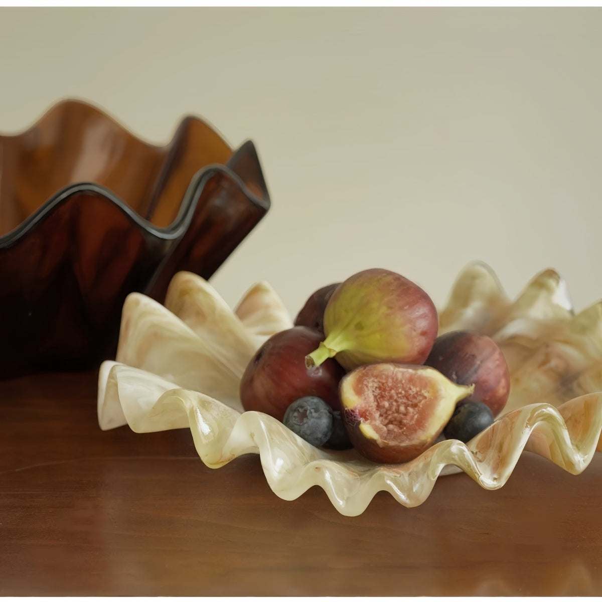 Vintage shell-shaped resin fruit bowl with scalloped edges on living room tabletop