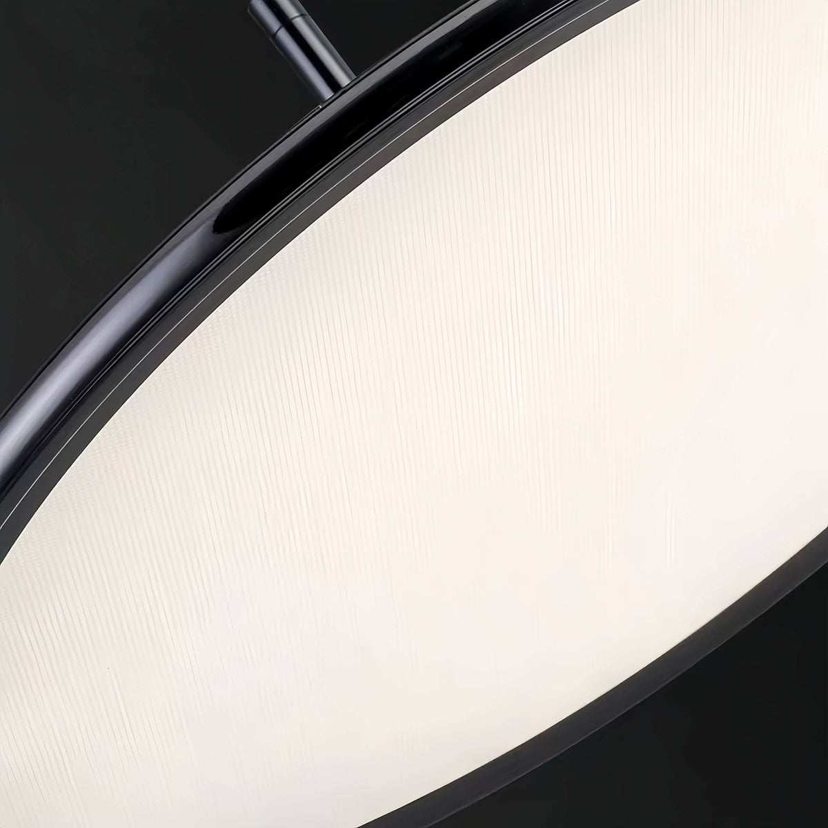 Close-up of minimalist dining pendant light with black aluminum frame and diamond acrylic panel diffuser