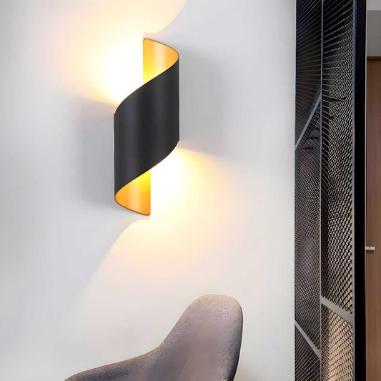 Postmodern unique sconce light with black metal curved design and warm ambient lighting on wall above chair