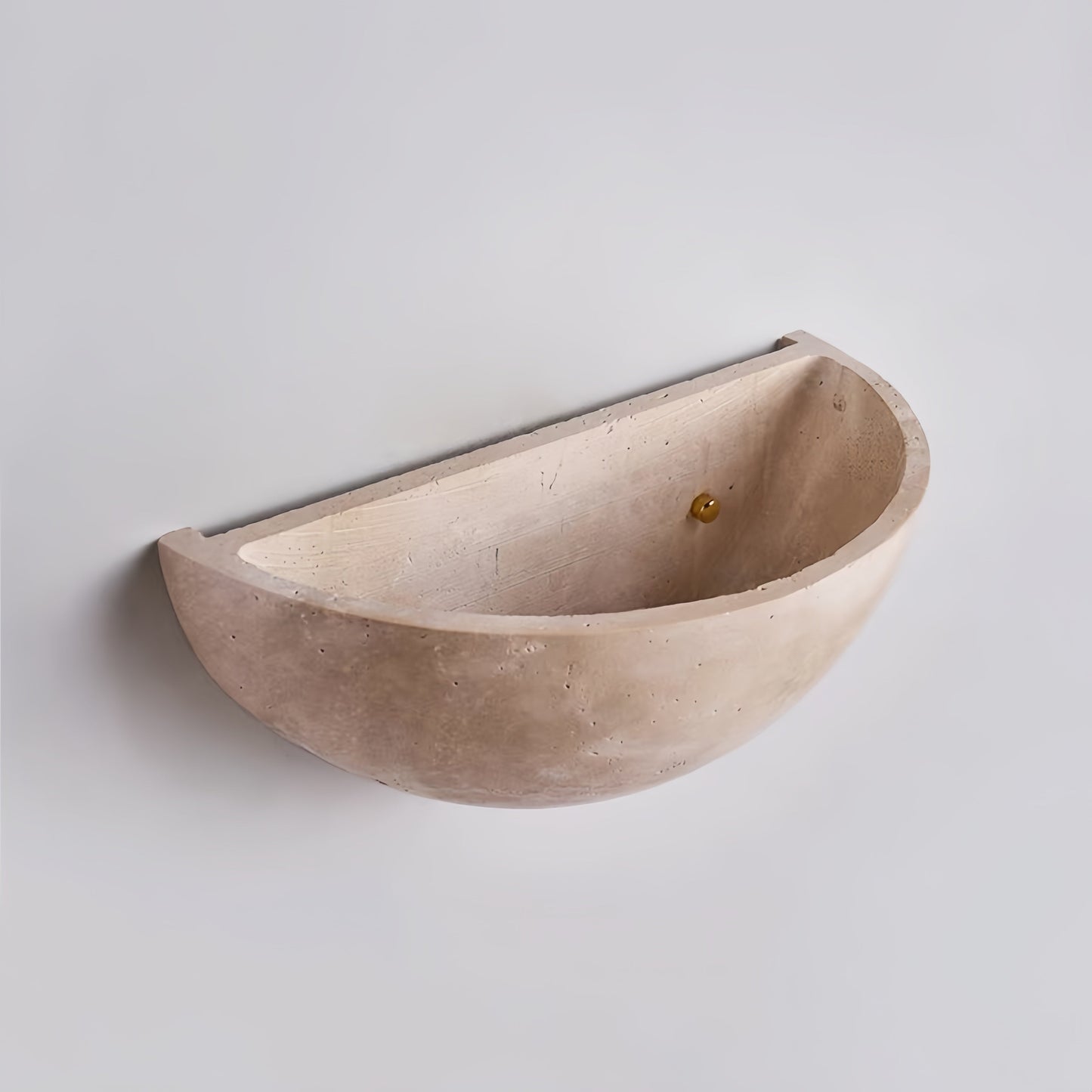 Vintage Wabi-Sabi style wall sconce made of natural off-white travertine with a seamless, hand-polished half-moon design and soft light effects.