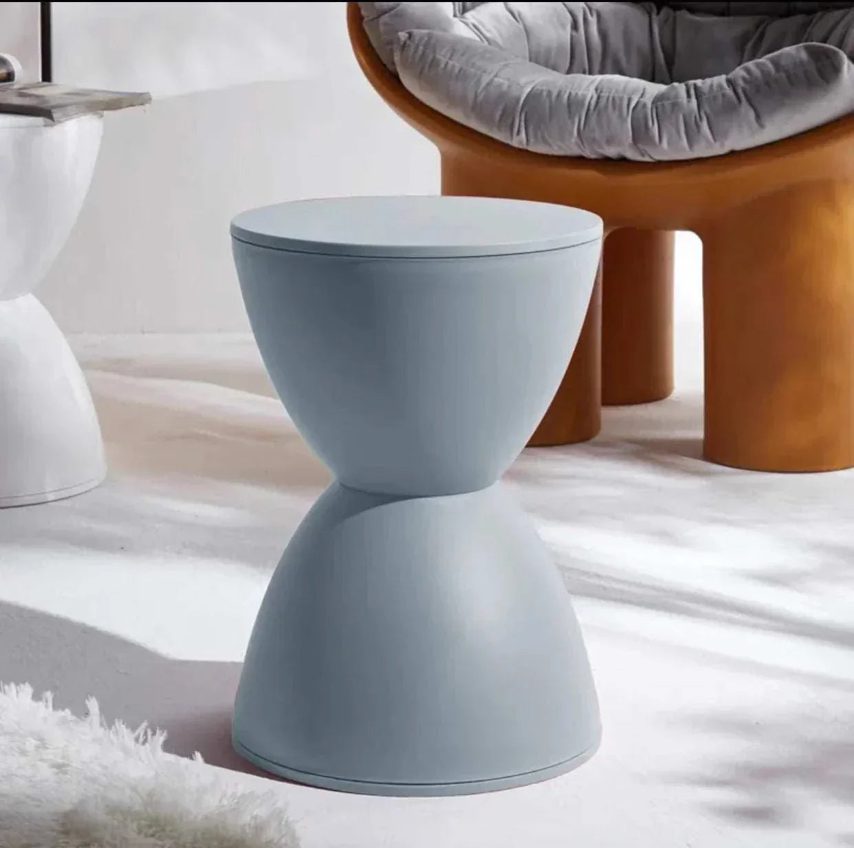Minimalist modern dressing table stool in light blue with smooth curved design and multifunctional use