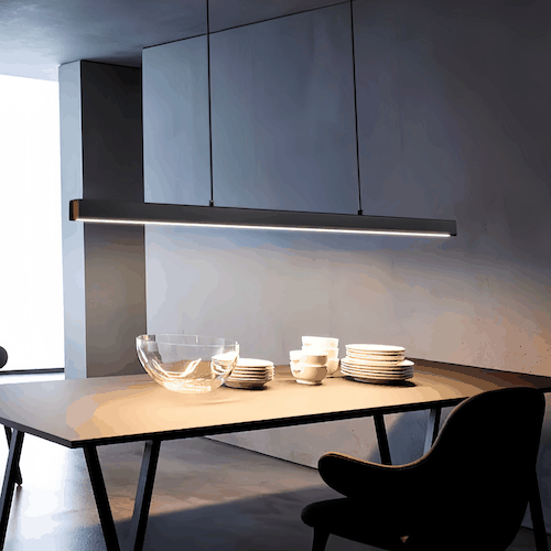 Modern black pendant light with dimmable LED and adjustable hanging wire over dining table