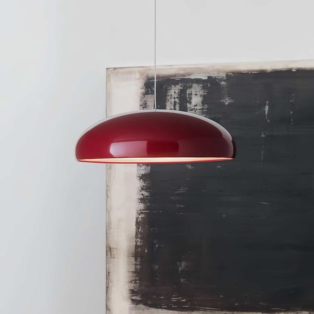 Modern minimalist red pendant light hanging in stylish living room interior