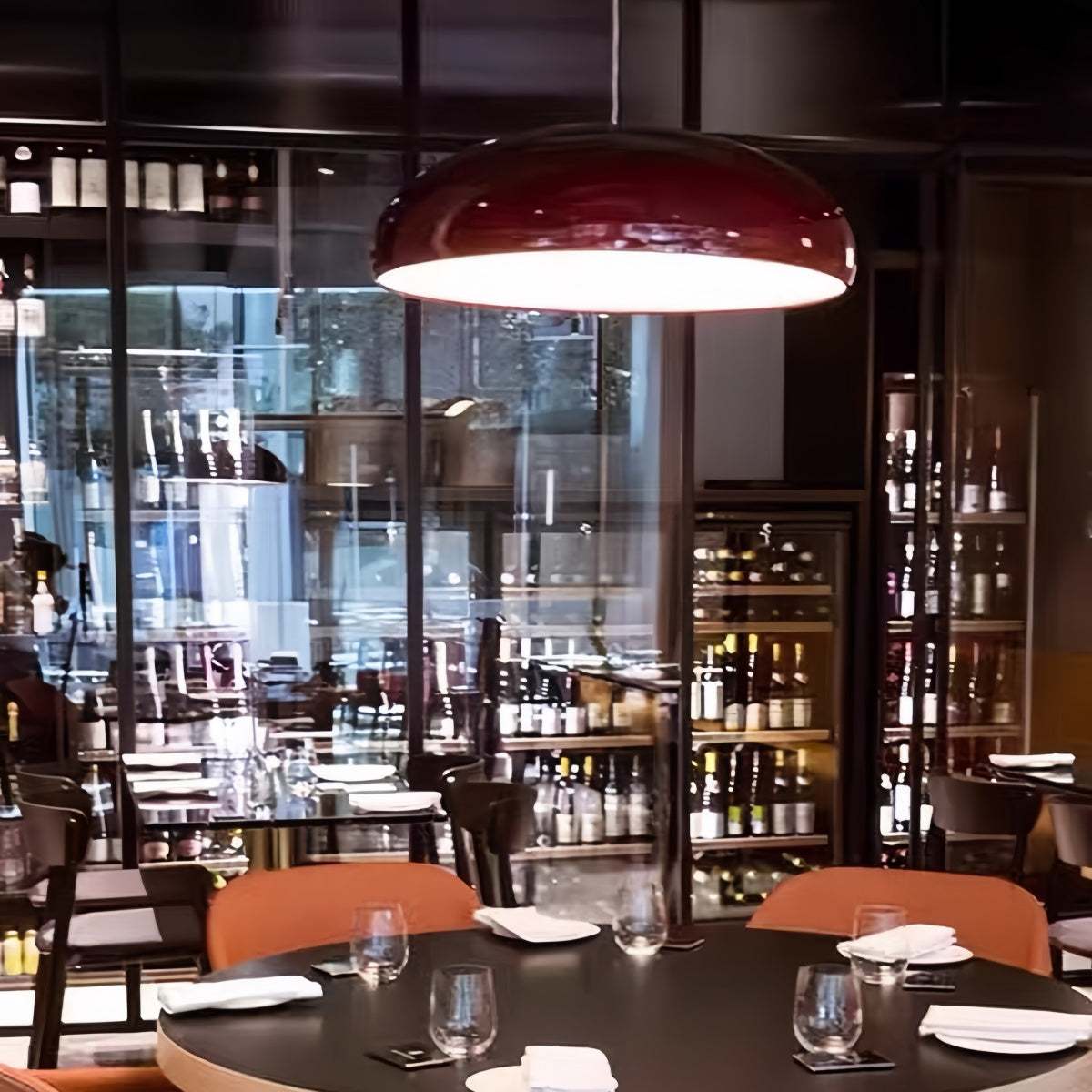 Modern minimalist red pendant light hanging in a stylish living room interior